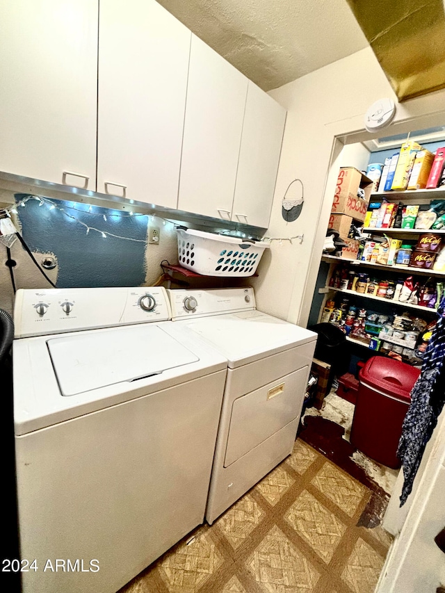 washroom with cabinets, a textured ceiling, and separate washer and dryer