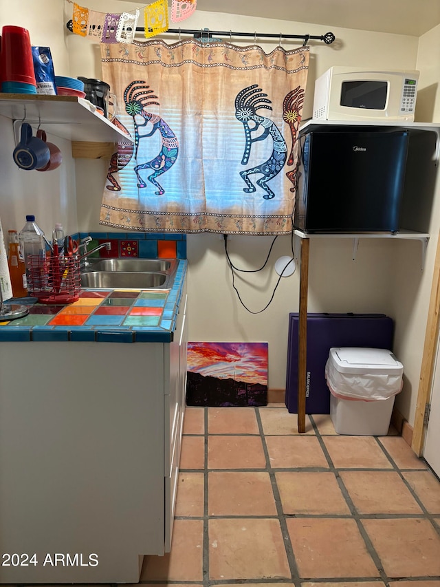 interior space with tile patterned flooring and sink