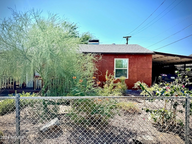 view of side of home featuring a carport