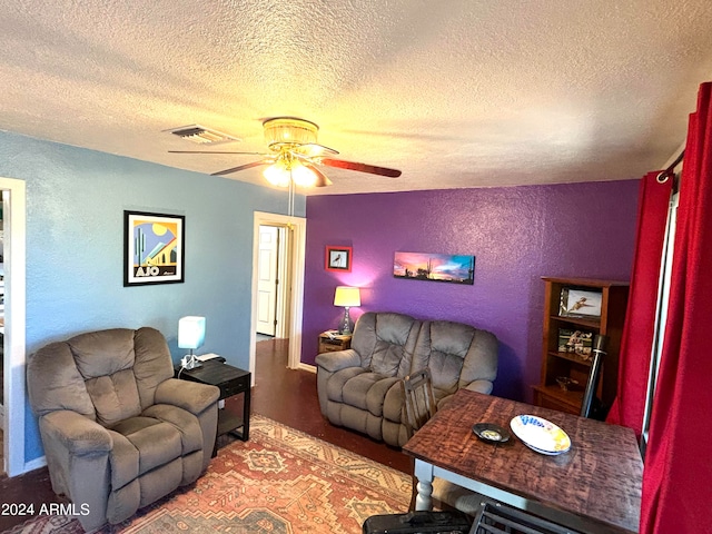 living room featuring a textured ceiling and ceiling fan