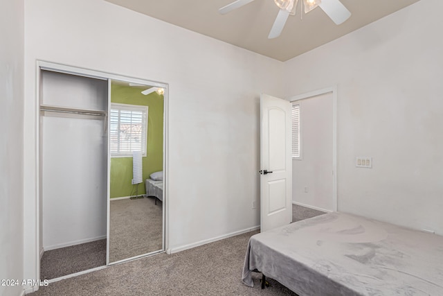 carpeted bedroom with a closet and ceiling fan