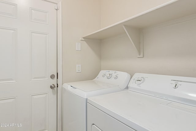 laundry area with washing machine and clothes dryer