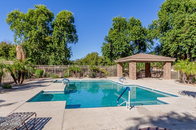 view of swimming pool with a patio and a gazebo