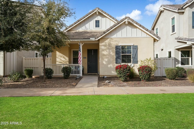 view of front of home featuring a front yard and a porch