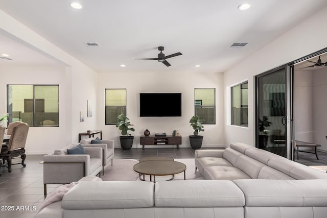 living room featuring ceiling fan and tile patterned flooring