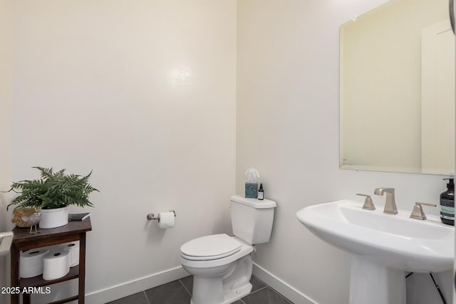 bathroom with tile patterned flooring, sink, and toilet