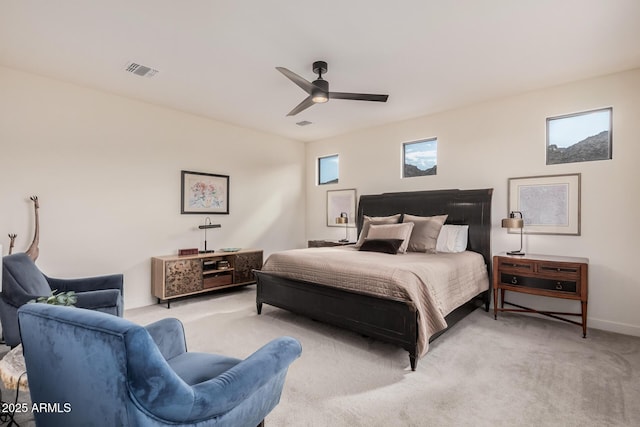 bedroom with ceiling fan and light carpet