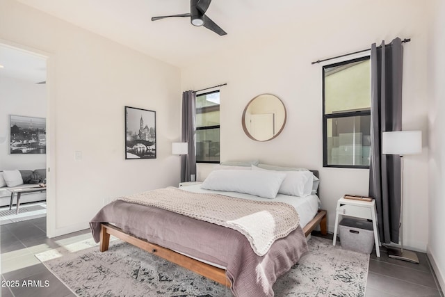 tiled bedroom featuring ceiling fan