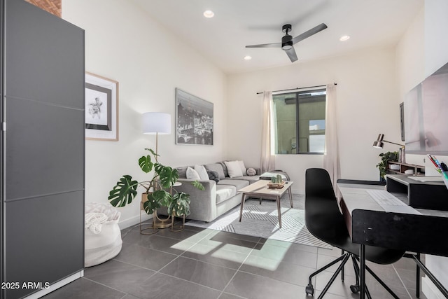 home office featuring ceiling fan and dark tile patterned floors