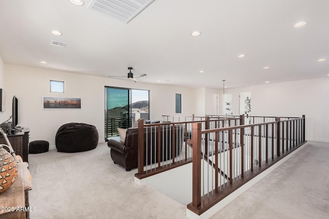 interior space with light colored carpet and ceiling fan