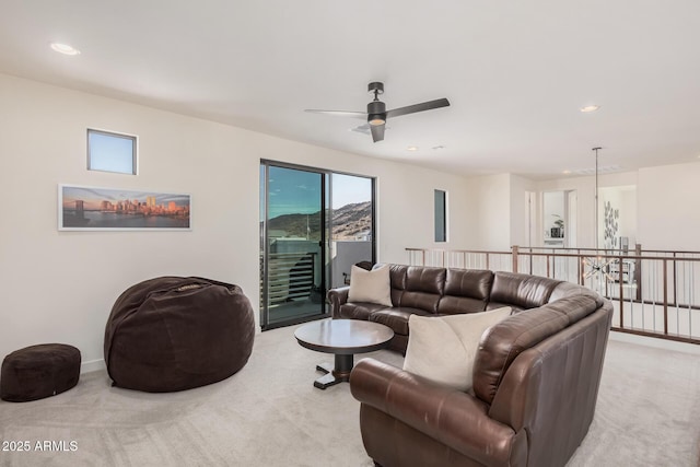 living room featuring light colored carpet and ceiling fan