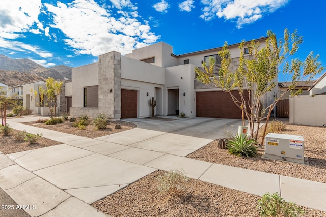 view of front facade featuring a garage and a mountain view