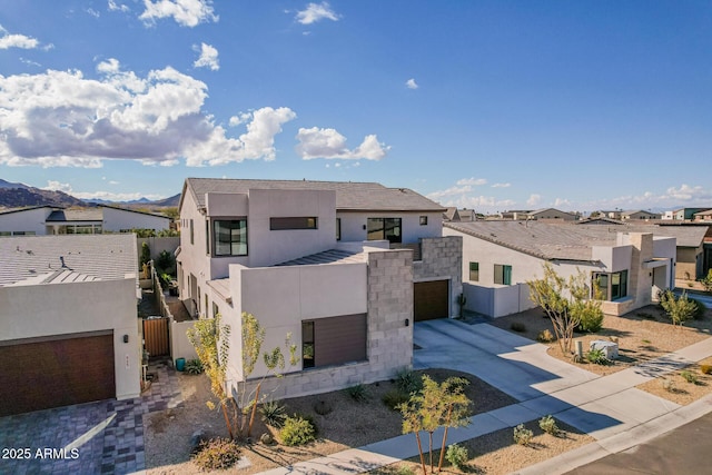 contemporary home with a garage and a mountain view