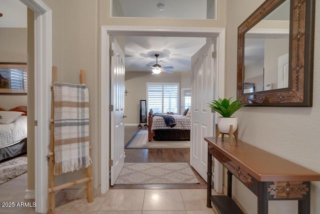 bedroom with ceiling fan and light tile patterned floors