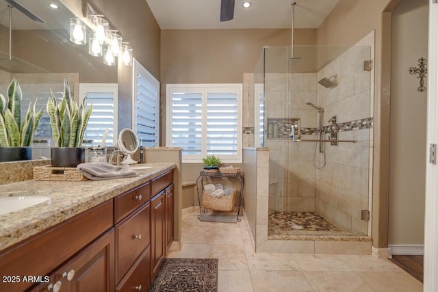 bathroom featuring vanity, a healthy amount of sunlight, tile patterned floors, and walk in shower