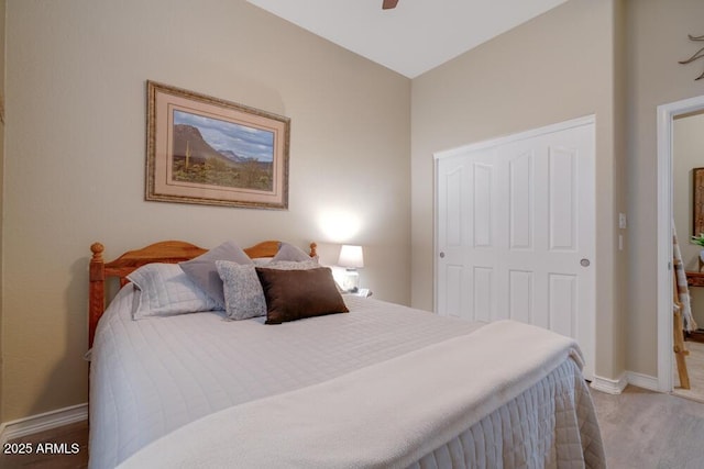 bedroom with a closet, ceiling fan, and light wood-type flooring