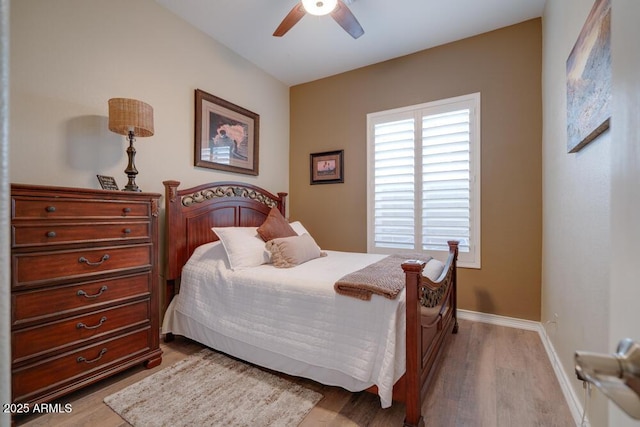 bedroom with ceiling fan and light hardwood / wood-style floors