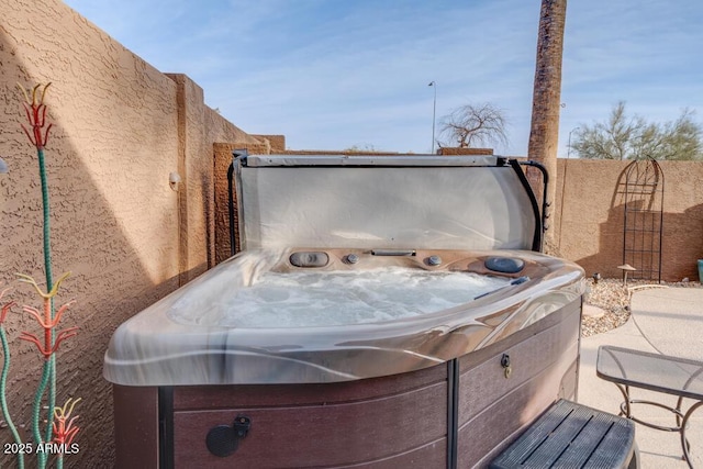 view of patio / terrace with a hot tub