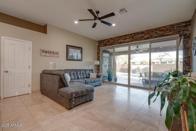 living room featuring ceiling fan, light tile patterned floors, and a wealth of natural light