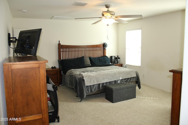 bedroom featuring ceiling fan, baseboards, visible vents, and light carpet