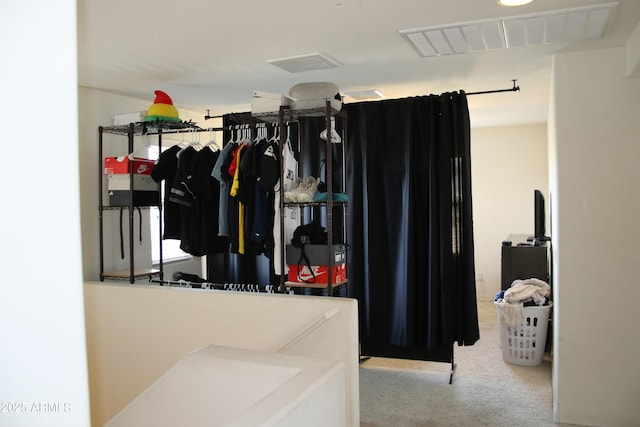 walk in closet featuring visible vents and carpet