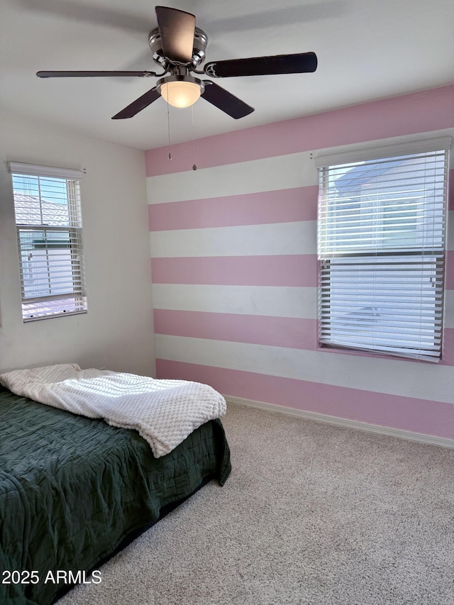 bedroom featuring carpet flooring, a ceiling fan, and baseboards