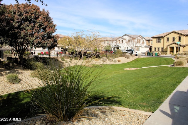 surrounding community featuring a residential view, a yard, and fence