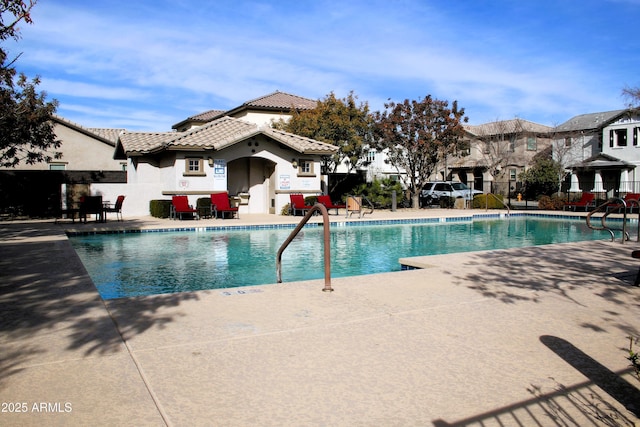 pool featuring a patio area and fence