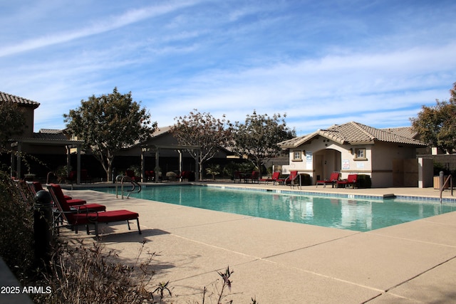 community pool with a patio area