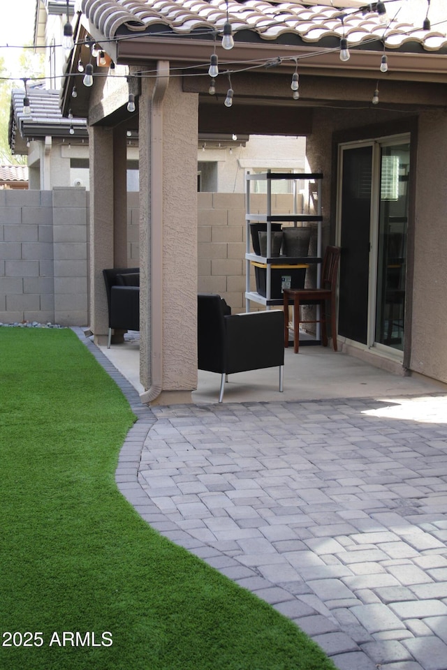 view of patio / terrace featuring fence