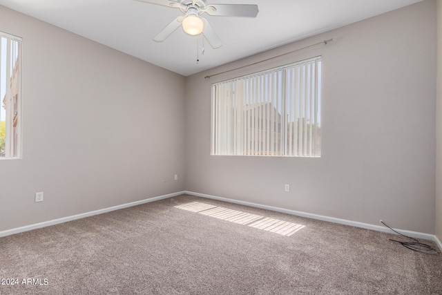 carpeted empty room featuring ceiling fan