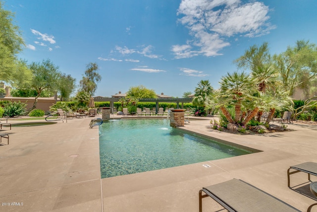 view of pool featuring pool water feature and a patio