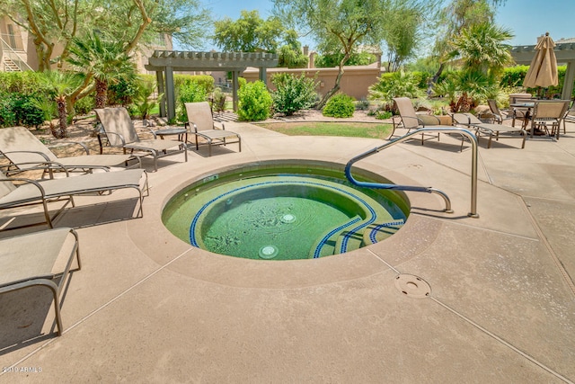 view of pool with a patio area and an in ground hot tub