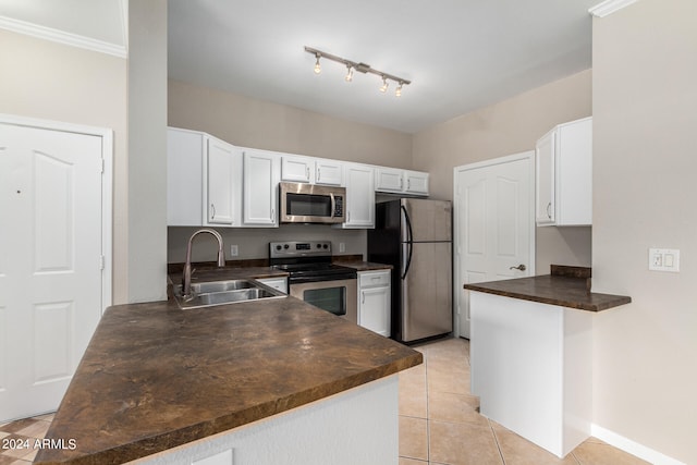 kitchen featuring kitchen peninsula, appliances with stainless steel finishes, sink, white cabinetry, and light tile patterned flooring