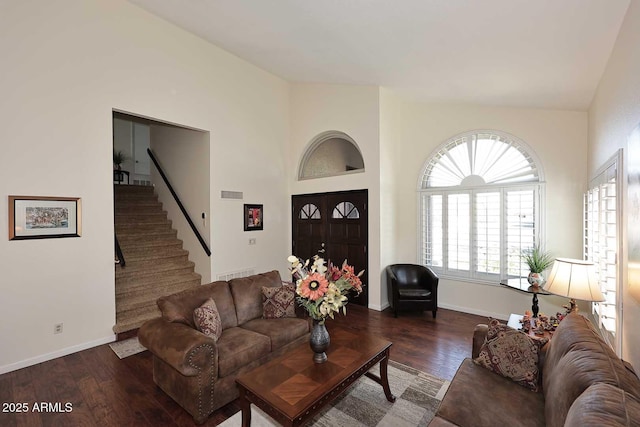 living room featuring dark wood-style floors, visible vents, baseboards, and stairs