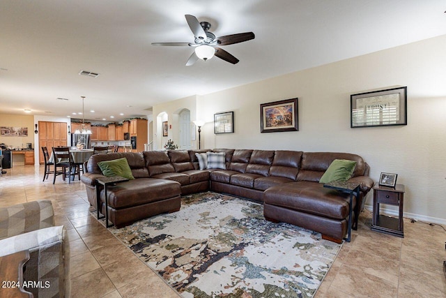 tiled living room featuring ceiling fan