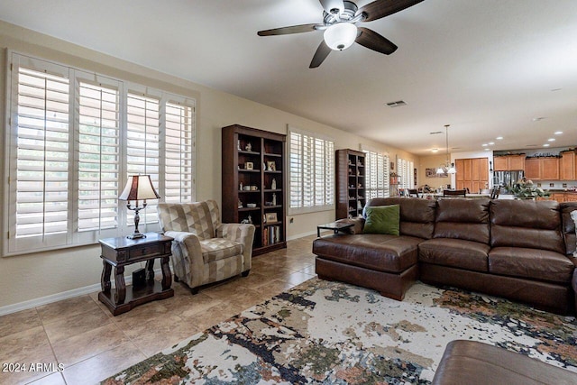 living room with a healthy amount of sunlight, ceiling fan, and light tile patterned floors