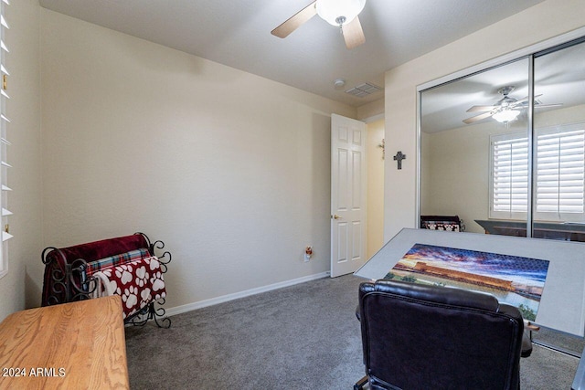 carpeted bedroom featuring ceiling fan and a closet