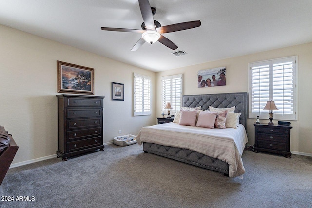 bedroom featuring carpet, ceiling fan, and multiple windows