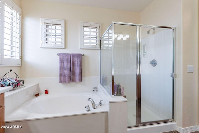 bathroom with vanity and separate shower and tub