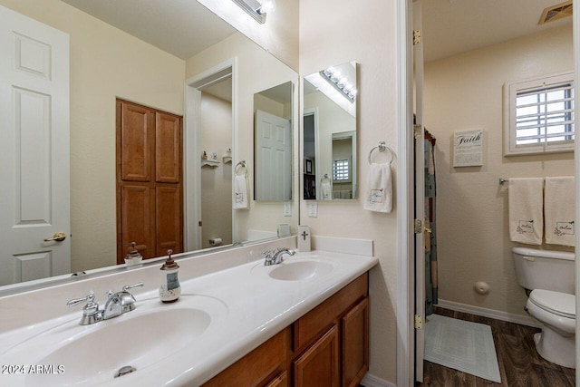 bathroom featuring vanity, toilet, and hardwood / wood-style floors