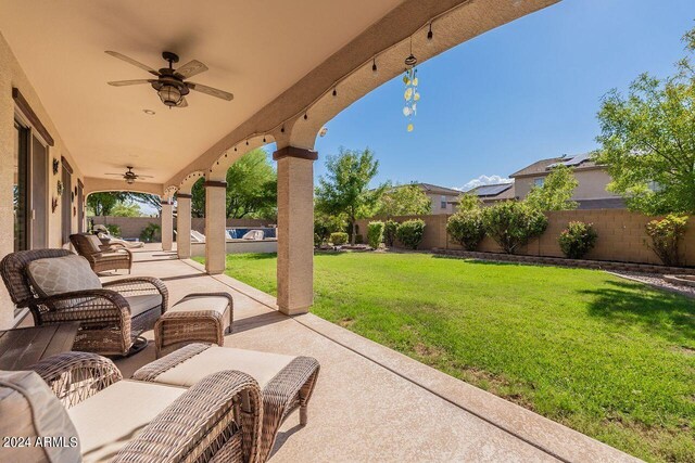 view of patio / terrace with ceiling fan and an outdoor living space