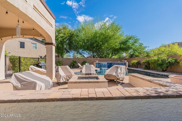 view of patio / terrace featuring area for grilling, a fenced in pool, and an outdoor fire pit