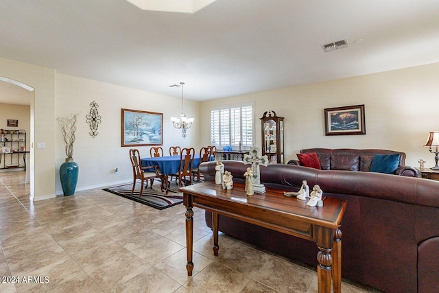 living room featuring a chandelier and light tile patterned floors