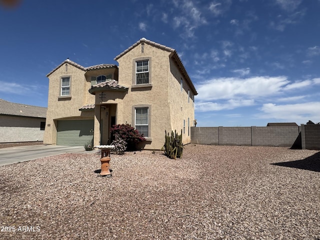 703 N Redwood Ln, Buckeye, AZ 85326 - view of front facade with stucco siding, concrete driveway, a tiled roof, and a garage