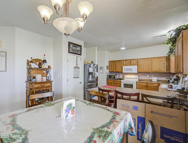 703 N Redwood Ln, Buckeye, AZ 85326 - dining area with a chandelier