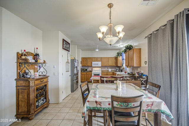 703 N Redwood Ln, Buckeye, AZ 85326 - dining area featuring a chandelier and light tile patterned floors