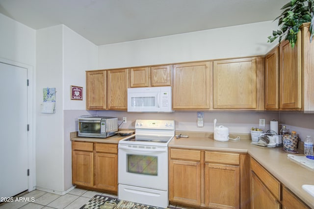 703 N Redwood Ln, Buckeye, AZ 85326 - kitchen featuring white appliances, light countertops, and light tile patterned floors