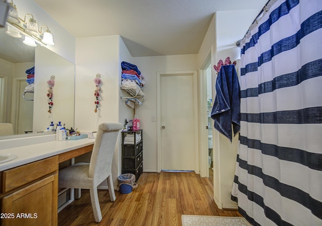 703 N Redwood Ln, Buckeye, AZ 85326 - full bathroom featuring wood finished floors, vanity, and curtained shower