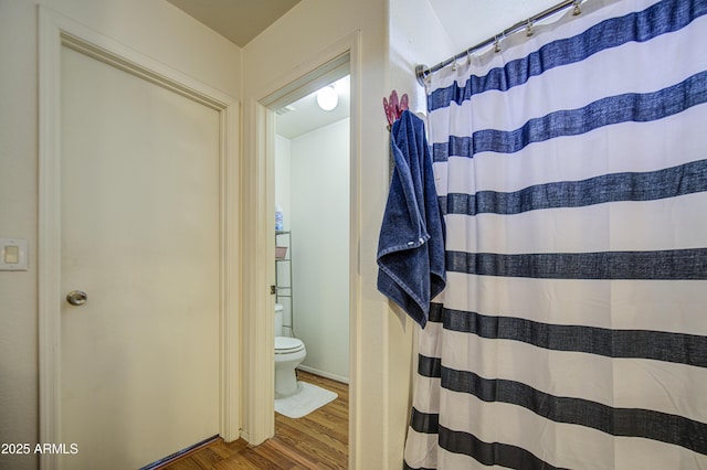 703 N Redwood Ln, Buckeye, AZ 85326 - full bathroom with toilet, wood finished floors, and a shower with curtain